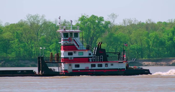 River boat pushing barge up the Mississippi river (no markings on boat)
