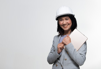 Beautiful Asian Smart Architect Engineer 50s 60s years old woman in white hard hat helmet hold tablet iot, portrait studio lighting gray background copy space, concept aging society woman can do