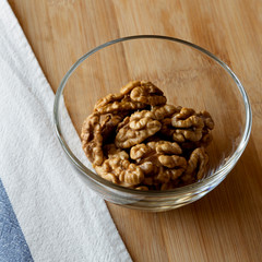 Walnuts in glass bowl, closeup.