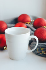 Empty white mug on the background of christmas tree decorations