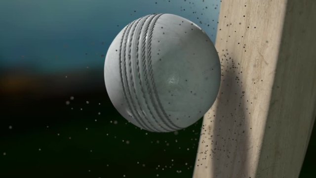 A ramped ultra motion close up of a white leather stitched cricket ball hitting a wooden cricket bat with dirt particles emanating from the impact at night