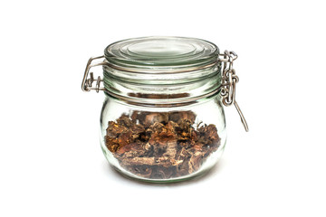 cut dry root of Rhodiola rosea in a glass jar on natural white background