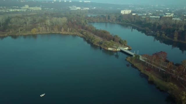 Aerial footage over Echo Park Lake, Kishinev, Moldova republic of. View of lake and smille bridge.