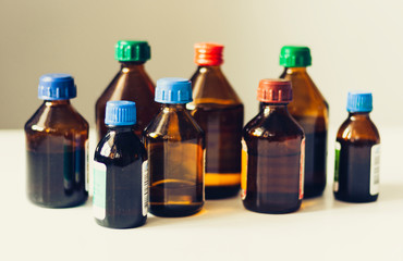 Medicine bottles on white background with copy scape for text, retro concept closeup.
