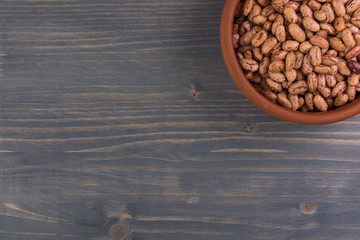 A plate of beans on wooden table background