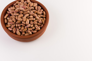 A plate of beans on white background