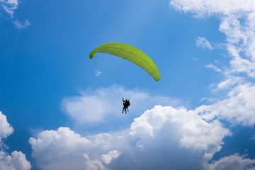 Poster de jardin Sports aériens Deux personnes volent en parapente dans le ciel