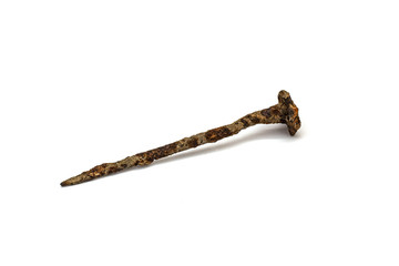 Antique wrought iron nail of the 18th century with rust on a white isolated background
