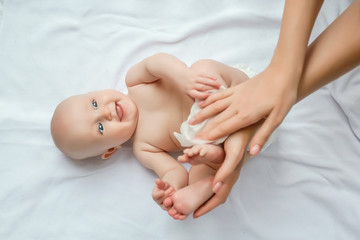Mother cleaning up and wipes body and leg baby by wet tissue. Cleaning wipe, pure, clean. happy...