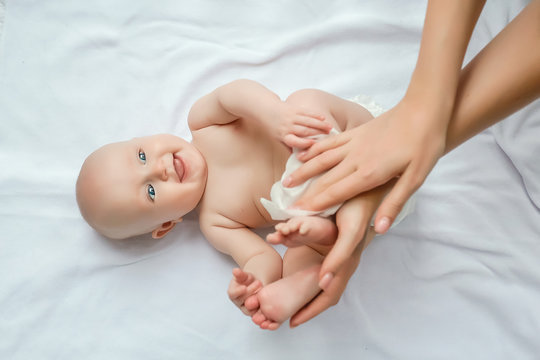 Mother Cleaning Up And Wipes Body And Leg Baby By Wet Tissue. Cleaning Wipe, Pure, Clean. Happy Emotions Of Newborn Baby