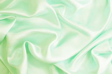 Obraz premium Smooth elegant green silk or satin texture can use as abstract background, fabric design