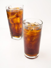Drink cola with ice in glass on white background