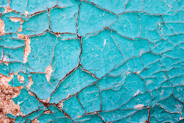 cracked blue paint on a wooden surface