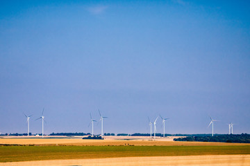 Turbine windmills for generating electricity in environmentally friendly way are installed in field