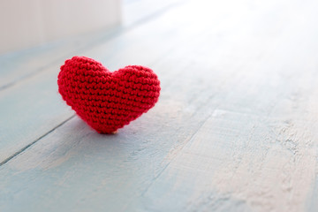 Fototapeta premium Heart made of red yarn on wooden background. Valentine day concept.