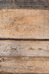 a wall of old wooden planks hammered in with nails