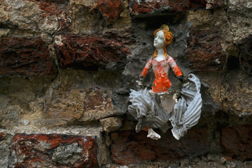 Doll in a wall closeup