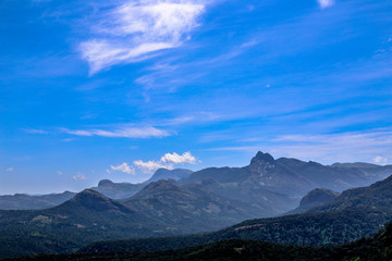 Fototapeta premium Clouds on mountains, lots of mountains at valparai, India