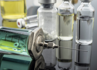 Vintage syringe with vials, conceptual image
