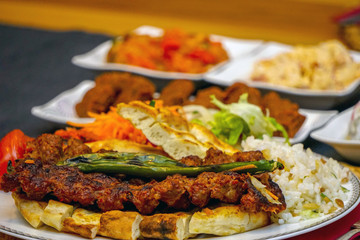 Turkish adana kebab with appetizers close up