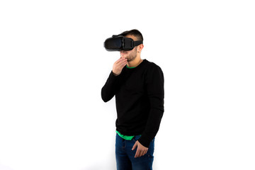 Bearded Thoughtful and confused young nice and modern with vr glasses that enjoy virtual reality with simulator isolated over white background