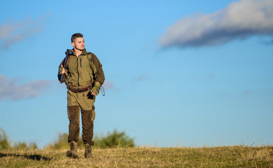 Hunting weapon gun or rifle. Hunting hobby. Guy hunting nature environment. Masculine hobby activity. Man hunter carry rifle blue sky background. Experience and practice lends success hunting
