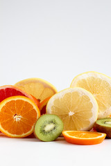 Layers of sliced fruits - kiwi, orange and grapefruits, close up