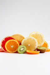 Layers of sliced fruits - kiwi, orange and grapefruits