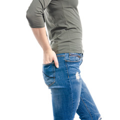 Woman in blue jeans and green shirt hand in pocket macro on white background isolation