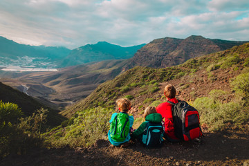 Fototapeta premium father and two kids hiking travel in mountains
