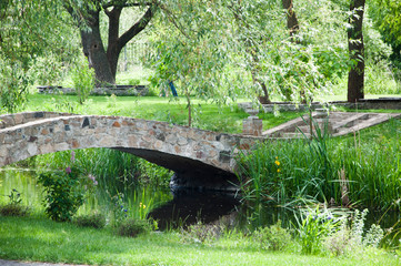 The perfect outdoor space. Stone bridge on summer landscape. Old stone bridge in botanical garden. Landscape park. Landscape architecture and landscaping. Summer vacation and wanderlust