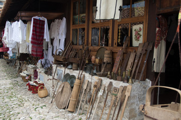 Fototapeta na wymiar KRUJE, ALBANIA - June 2018: Traditional Ottoman market in Kruja, birth town of National Hero Skanderbeg. Flea market in Albania. Antique items and souvenirs for sale.