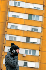 Woman talking on mobile phone on street in winter