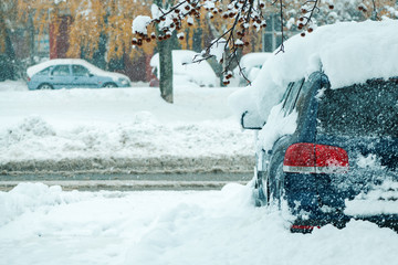 Automobile parking lot with cars covered in snow