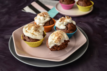 Colorful cupcakes on purple background