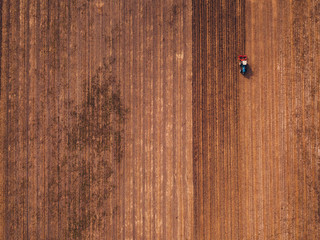 Aerial view of agricultural tractor doing stubble tillage © Bits and Splits
