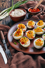Deviled Eggs sprinkled with paprika and onion