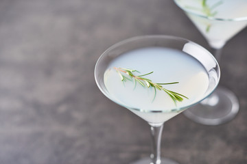 Summer drink. Refreshing summer alcoholic cocktail with rosemary and citrus fruits or sparkling gin and lemonade on dark concrete table. Copy space for text. Horizontal. Selective focus.