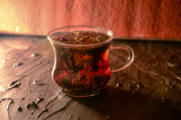 A cup of tea with different herbal and cinnamon. Cold weather concept