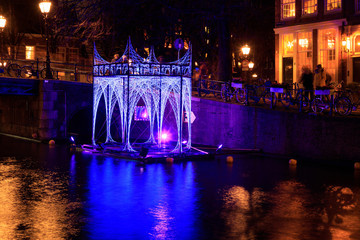 Luminous arbor on the water of the canal of Amsterdam