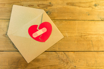Red broken heart in an envelope.