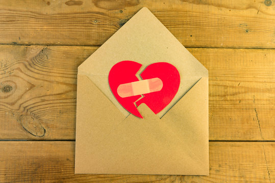 Red broken heart in an envelope.