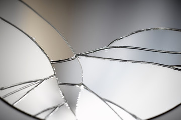 Crack and broken mirror in a front view image.