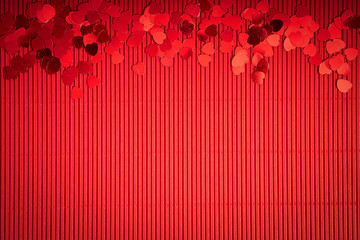 Beautiful Valentines Day background with red ribbed paper with heart-shaped confetti