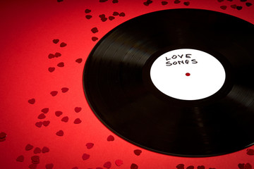 Valentines Day background with black LP record with love songs on red background