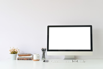 Workspace table office supplies on creative workplace with mockup computer empty display.