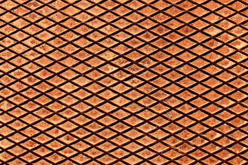 Rusty metal grid shape surface. Grunge orange industrial texture.