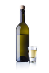 bottle and glass of grappa isolated on white