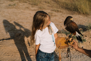 Little Girl with the bird rapacious in her hand