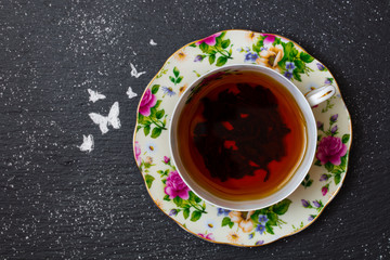 top view of  tea in porcelain cup on on slate tray 